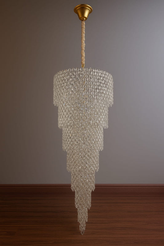 Chandelier hanging from the ceiling against a plain wall.