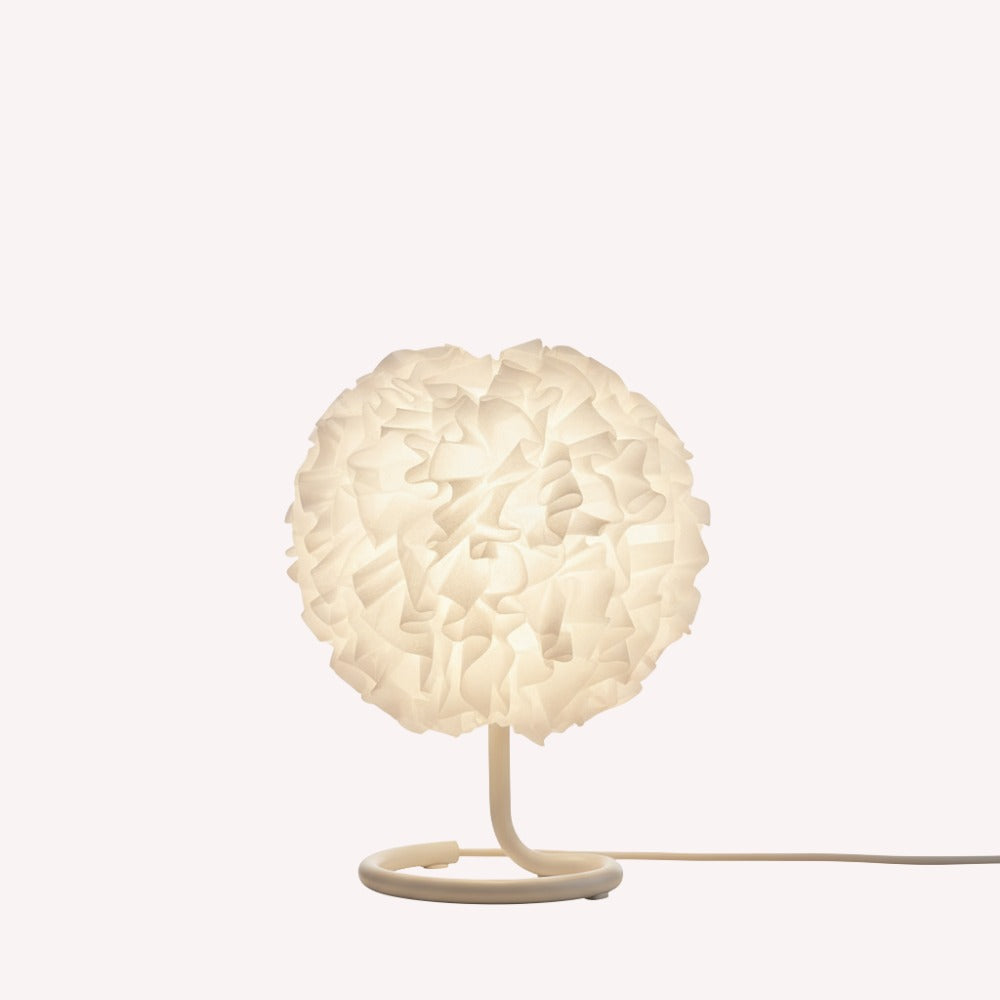 Table lamp with a white, textured shade on a white background