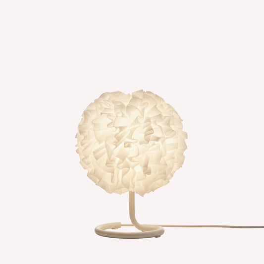 Table lamp with a white, textured shade on a white background
