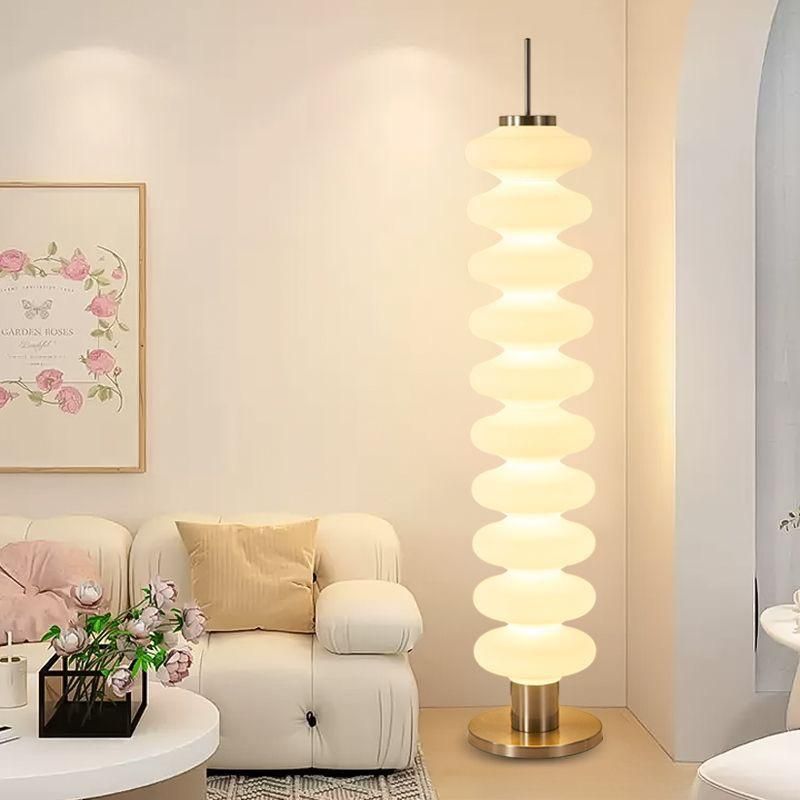 Modern living room with a decorative floor lamp, sofa, and coffee table.