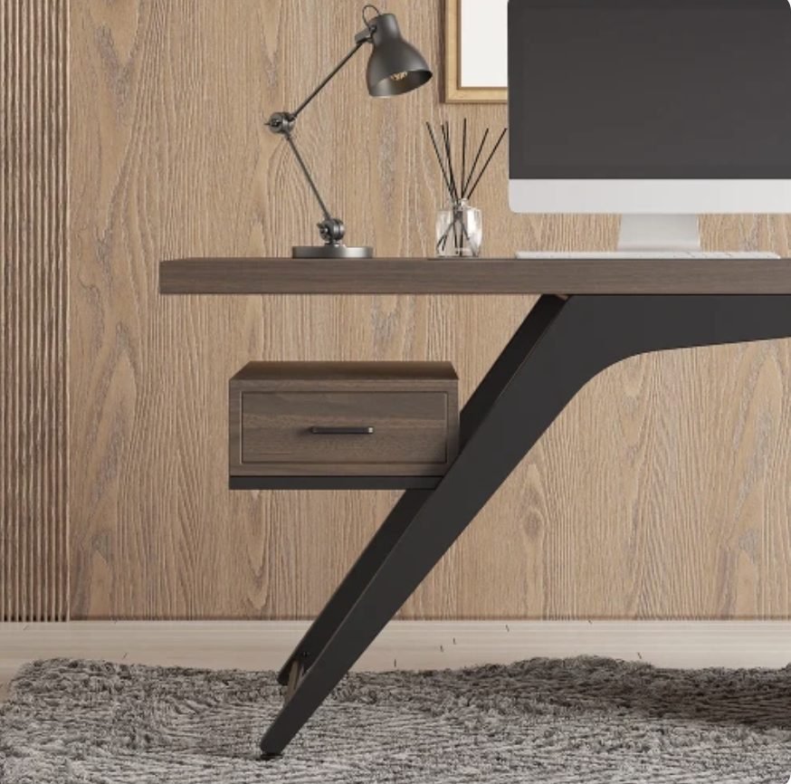 Close-up of the Axel desk angled black metal leg and floating drawer