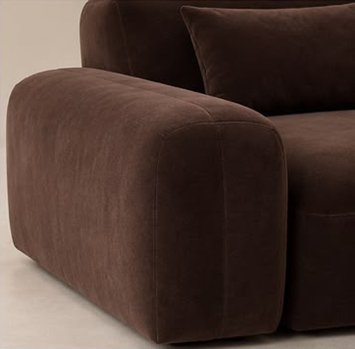 Close-up of rounded armrest and velvet-touch fabric