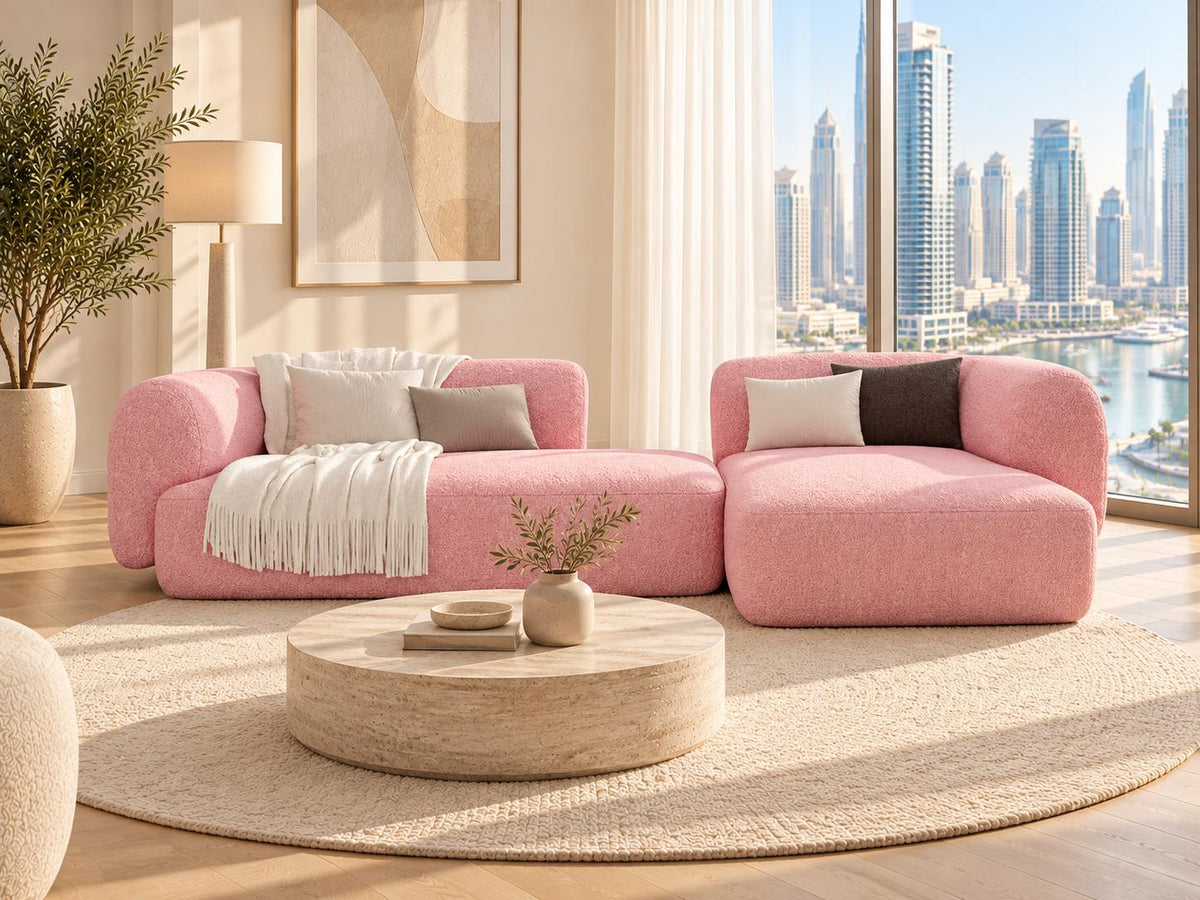 Pink bouclé L-shaped sofa in a bright Dubai Marina apartment living room