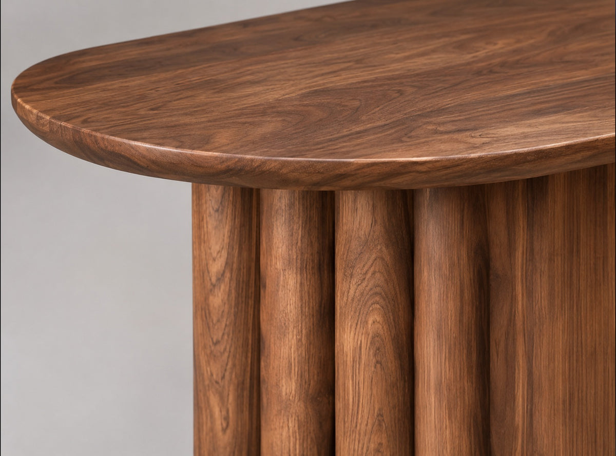 Close-up of the Ripple table walnut edge and five-column fluted leg
