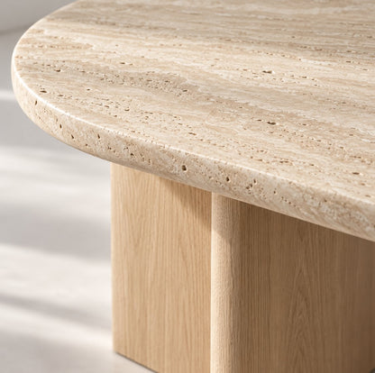Close-up of the rounded travertine edge and oak leg of the Sola dining table