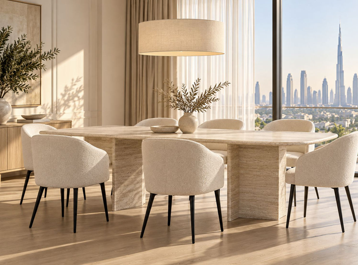 Travertine dining table in a bright Dubai apartment dining room with 8 boucle chairs