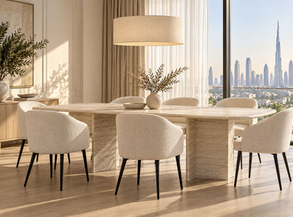 Travertine dining table in a bright Dubai apartment dining room with 8 boucle chairs