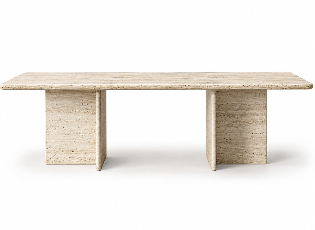Front view of the Terra travertine dining table with T-shaped stone legs